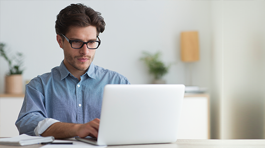 Man on computer working at home