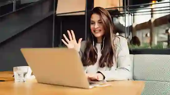 Woman waving during a video call